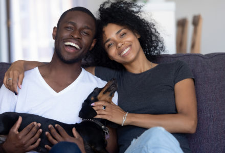 Couple on couch with dog